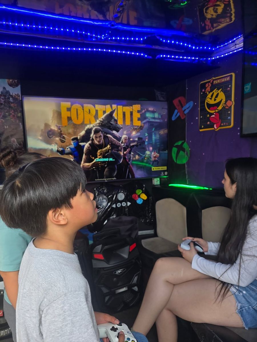 Interior of gaming truck with HDTV screens and consoles